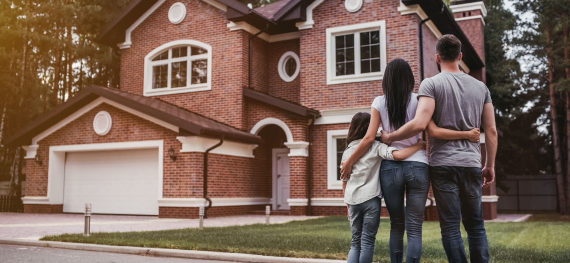 Back,View,Of,Happy,Family,Is,Standing,Near,Their,Modern